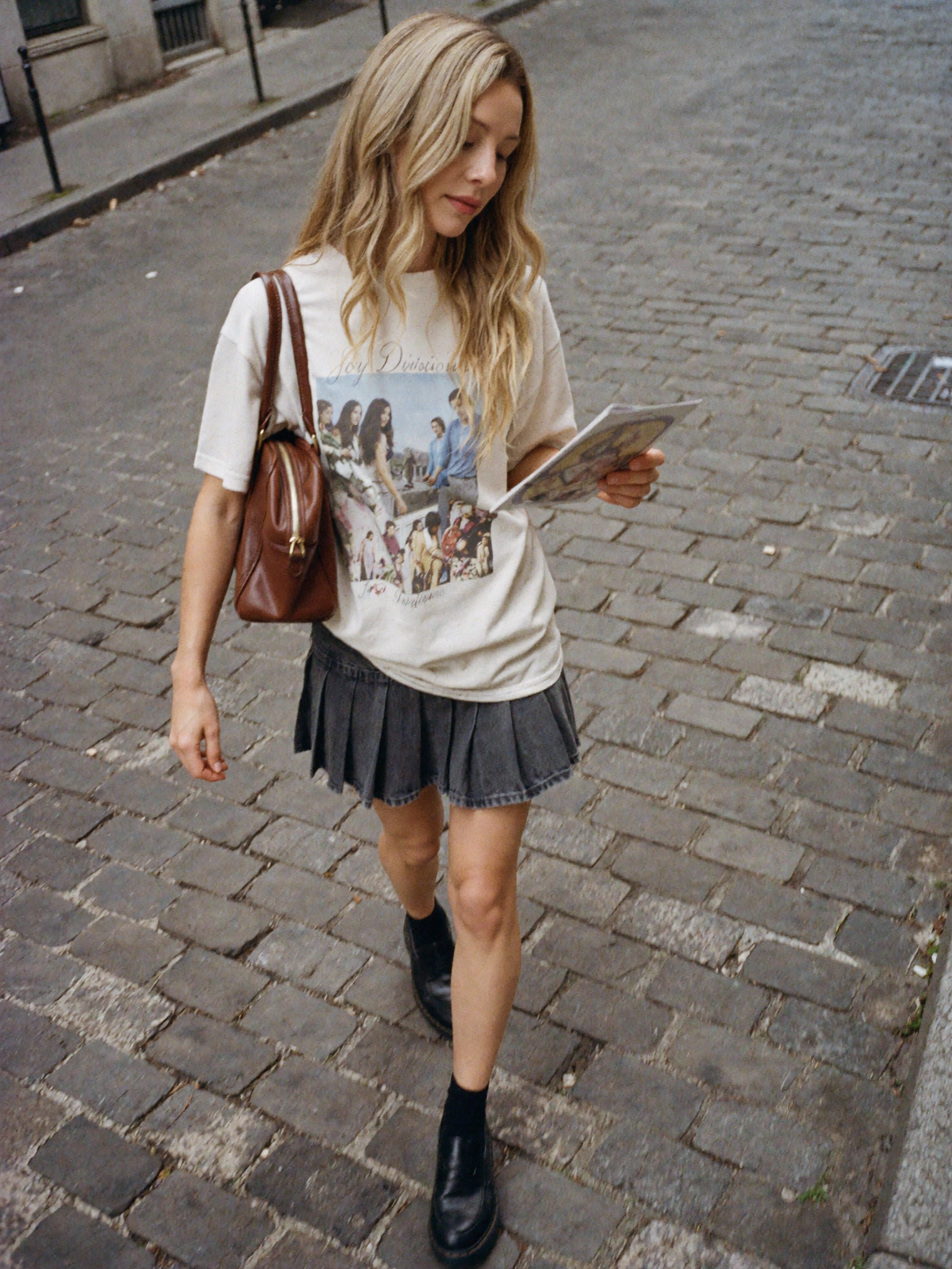 Street style portrait reading on cobblestone