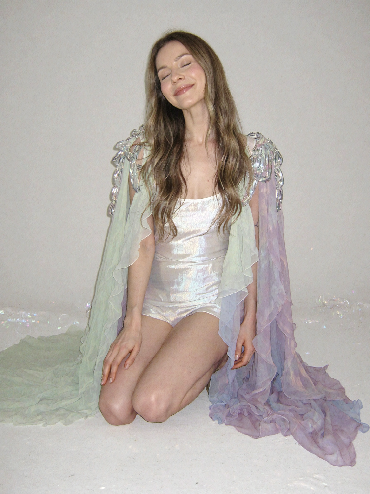 Ethereal portrait with iridescent fabric and pastel styling