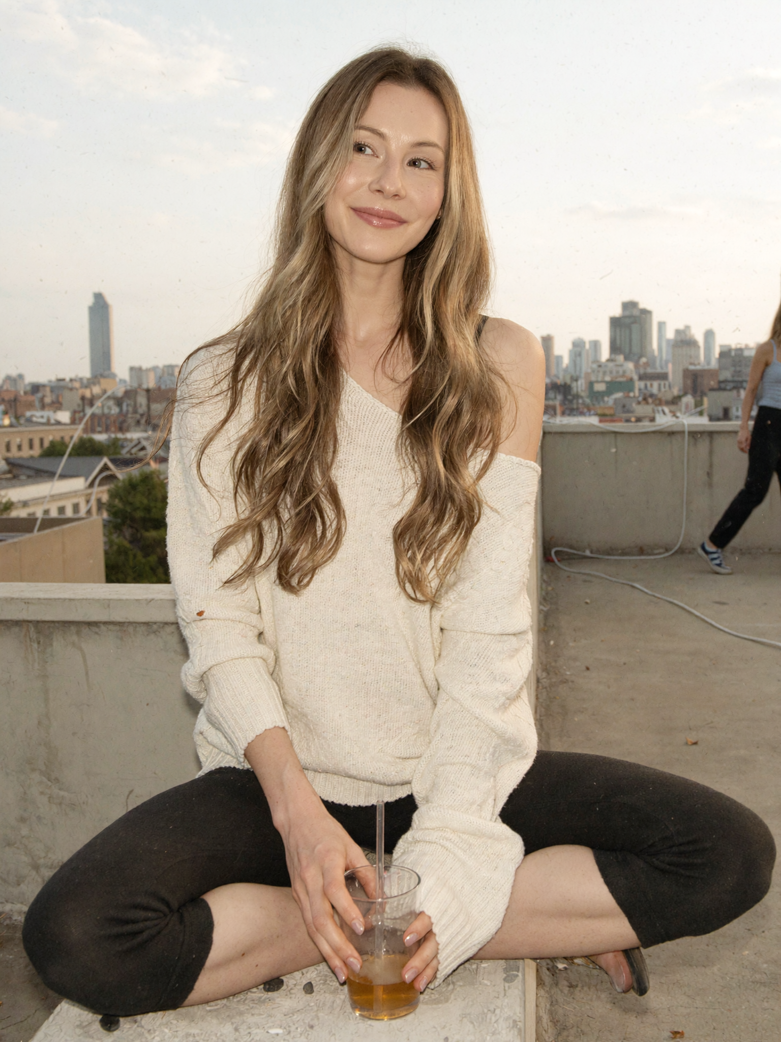 Rooftop portrait with city skyline at golden hour